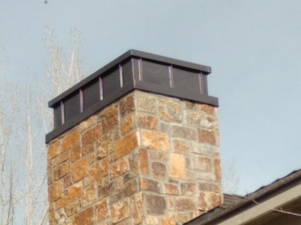 Custom sheet metal chimney caps made and installed by Aspen Roofing