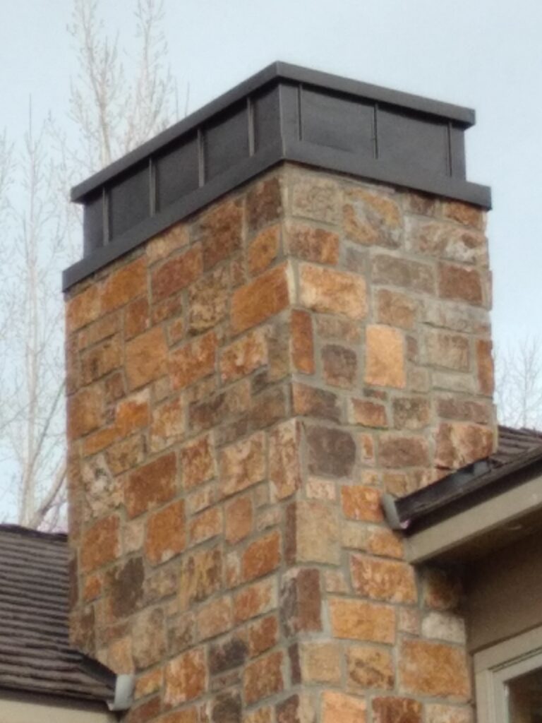 Custom sheet metal chimney caps made and installed by Aspen Roofing